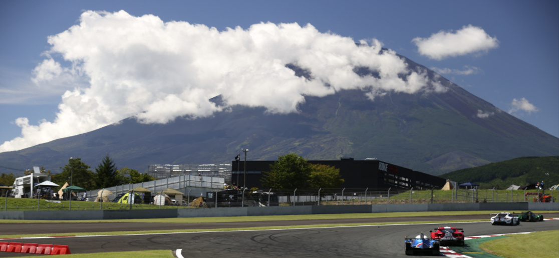 A Toyota Gazoo racing car on track in front of Mount Fuji in the background